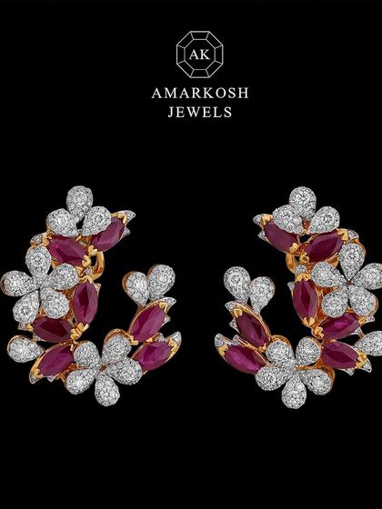 These elegant floral earrings feature a stunning blend of vibrant rubies and sparkling diamonds. Their timeless beauty and sophisticated design make them a versatile addition to any jewellery collection.