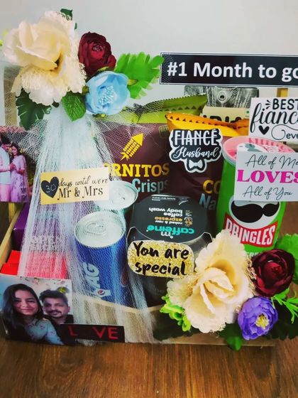 A sweet and simple countdown hamper for a fiancé, marking one month until the wedding. It's a compact yet thoughtful gift with Pringles, a drink, and personalized notes and photos.