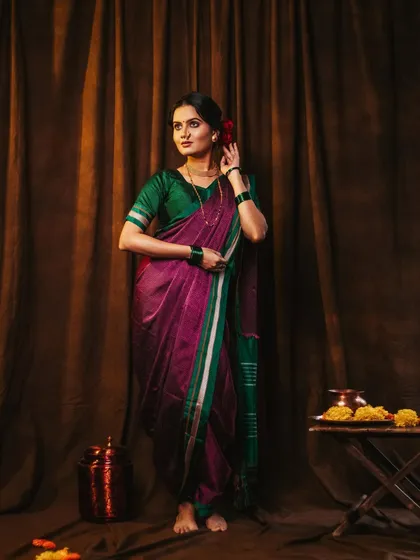 A full-length standing pose, showing the elegant drape of the Nauvari saree.