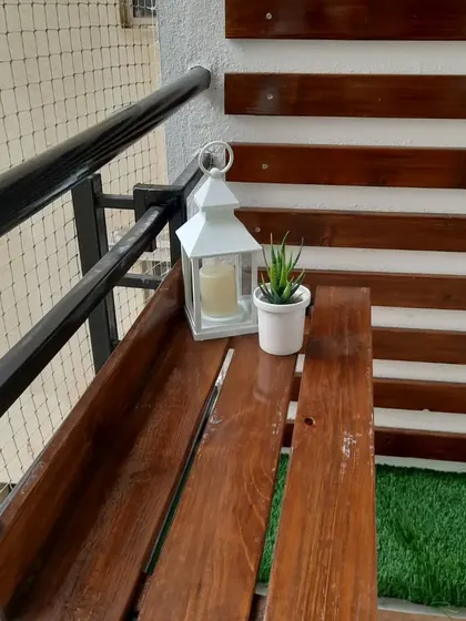 Detail of the custom-made railing bench. It's a great space-saving solution that provides a handy spot for a lantern, a small plant, or your evening cup of tea.