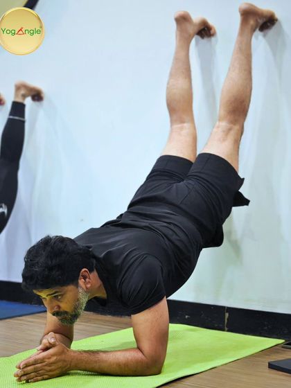 The wall is one of the best props we have. Here, a student practices a forearm stand against the wall, building the core and shoulder strength necessary for freestanding inversions in a safe, supported way.