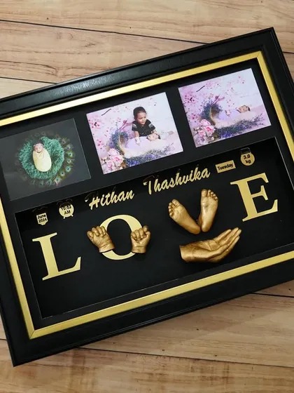 A custom "LOVE" themed casting frame, with 3D impressions of a baby's hands and feet, along with family photos. A truly unique piece of art.