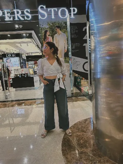 This casual mall outfit, a wrap top with wide-leg jeans, is perfect for a day of shopping. It is comfortable, stylish, and shows how to look put-together even on a relaxed day.