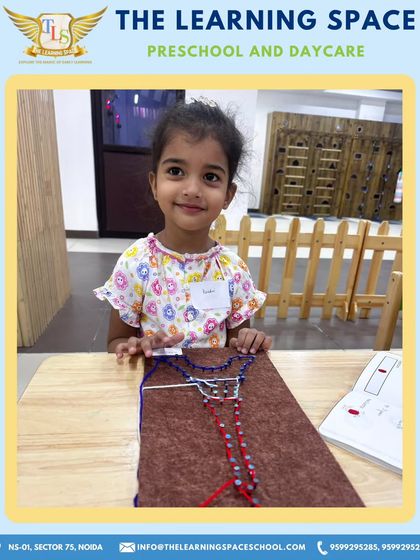 A proud smile and a finished Eiffel Tower. Completing a craft project gives children a wonderful sense of accomplishment and a tangible reminder of their learning journey.