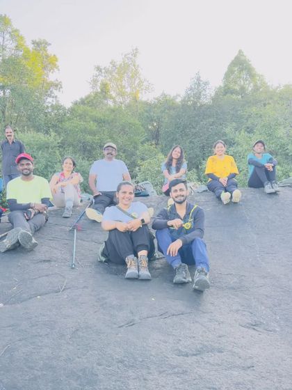 A group resting on a rock during the trek.