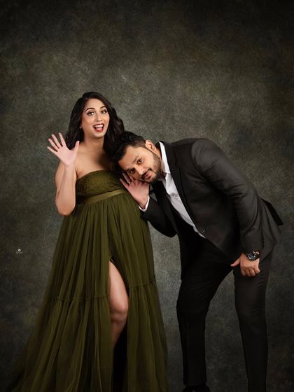 A fun and joyful couple portrait. The dad-to-be playfully listens to the baby bump, bringing a sense of humor and happiness to this elegant maternity session.