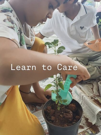 "Learn to Care." A child lovingly waters a plant during our gardening activity. This teaches them responsibility and a connection to nature.