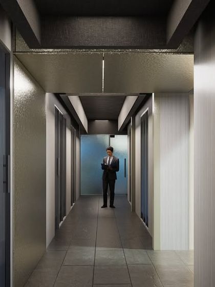 A corridor in the Fratelli office, where the interplay of light, geometry, and textured wall panels guides movement and creates a calm, focused atmosphere.
