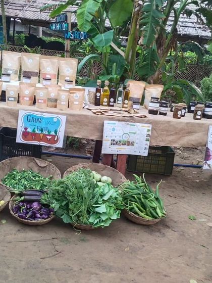 My stall at the Edible Routes Saturday Market. You can find a wide range of vegetables in baskets, alongside my packaged artisanal products like oils, pickles, and grains.