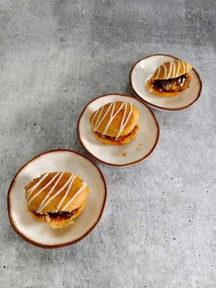 Soft golden buns filled with rich layers of flavor and topped with a delicate drizzle. These little beauties are proof that happiness really does come in small plates.
