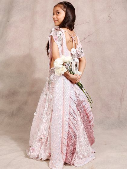 A beautiful shot of our pink ombre lehenga, highlighting the back detail and fabric.