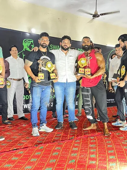 On stage with my winning clients. I don't just give you a plan, I guide you through the entire process, including posing and stage presence for competition day.
