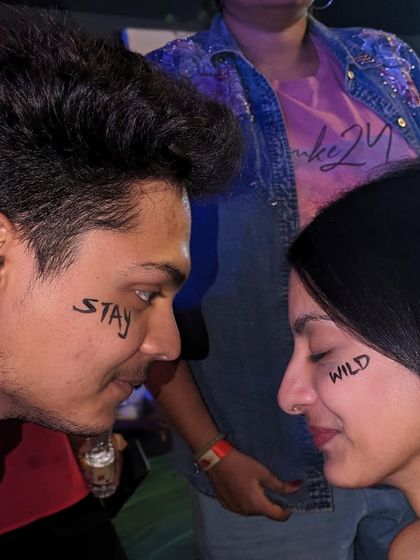 A cool and edgy concept for a couple: "Stay Wild" painted on their faces for a powerful photo.