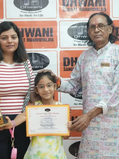 A senior guru with a student and her mother during the award ceremony.