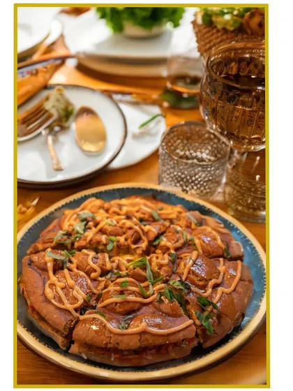 Introducing our innovative "Bubble Pizza". This unique dish deconstructs the classic pizza into bite-sized, pull-apart bubbles of dough, cheese, and sauce.