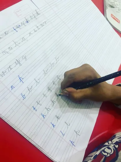 Back to basics with letter drills. This image shows a student practicing the formation of individual cursive letters, a crucial exercise for building a strong foundation in penmanship.