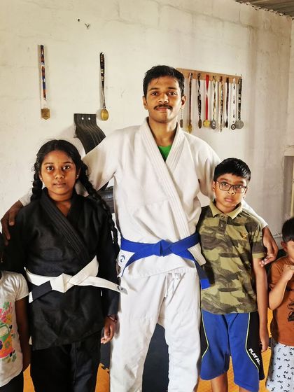 Our kids' BJJ team in their gis. The gi is a traditional uniform that we use as a tool for grips and control, adding another layer to their grappling education.