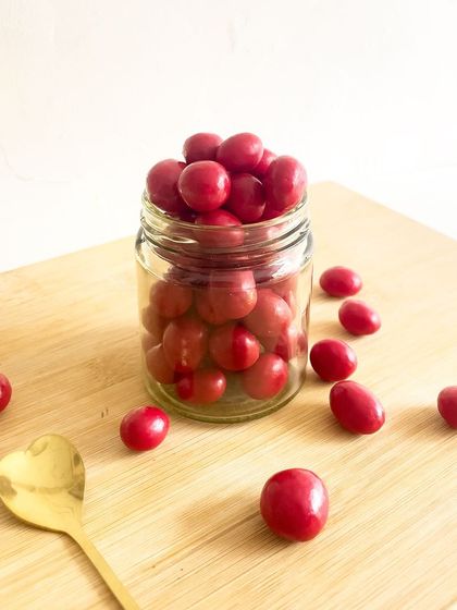 Tangy meets sweet in every bite of our cranberry panned nuts. These vibrant red treats are a delightful mix of crunchy nuts and a sweet-tart cranberry coating.