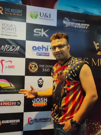 Posing in front of the sponsor wall at a major event. I'm experienced in performing at high-profile corporate and entertainment functions.