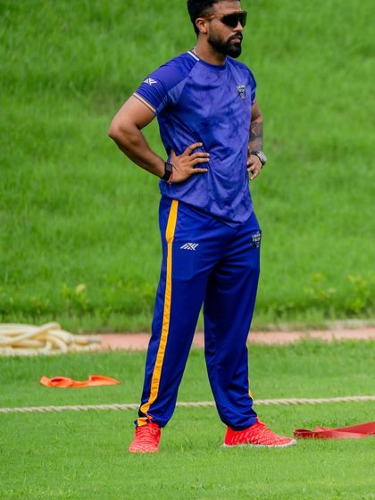 Standing on the field, observing the training session. My focus is always on the athletes, ensuring they are moving efficiently and staying prepared for the game.