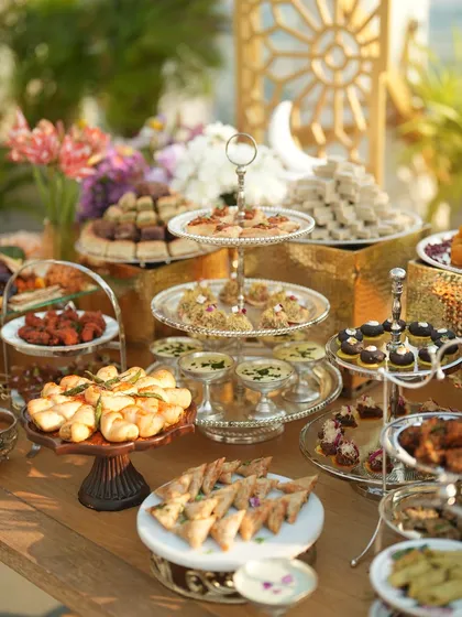 The dessert and appetizer table at sunset, glowing with warmth and promise of a delicious evening.