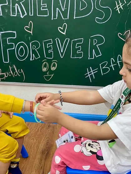 The first friendships are so precious. Here, two little buddies exchange friendship bands, a simple act that teaches them about caring for one another.