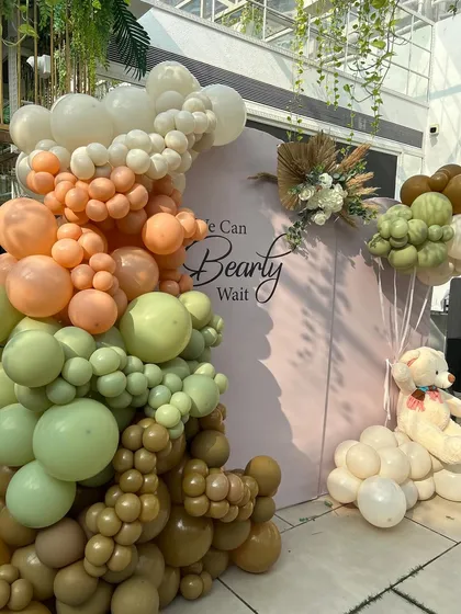 The full view of our earthy 'We Can Bearly Wait' backdrop, featuring a stunning organic balloon arch and a floating teddy bear. This setup is perfect for an elegant, gender-neutral baby shower.