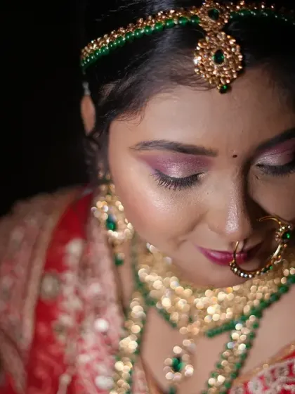 A serene and beautiful close-up of the bride. The soft lighting highlights her flawless makeup and the intricate details of her jewellery.