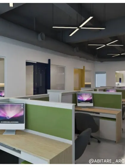 A view of the open-plan workspace at an office in Neemrana. We used low-height green partitions to define individual desks while maintaining a sense of connection and openness across the floor.