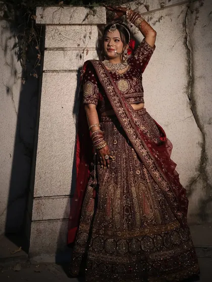 A powerful and confident pose from the bride. The lighting accentuates her features and the luxurious fabric of her outfit.