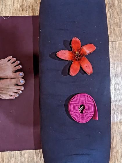 My practice essentials: a mat, a bolster for support, a strap for extension, and a flower to remind me of the beauty in every moment.