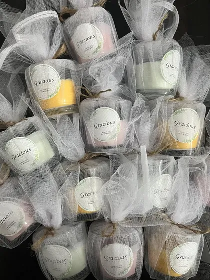 A large batch of our pastel tea light candles, all wrapped in net and ready to be gifted.