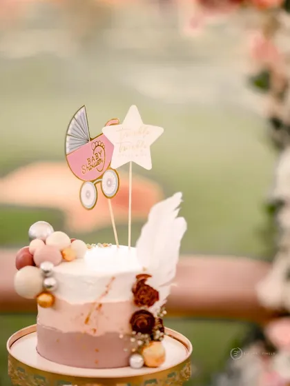 The details matter. This custom baby shower cake with a cute pram topper and delicate decorations was designed to perfectly match the event's theme and color palette.