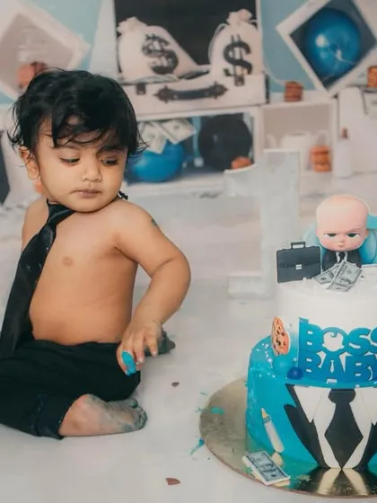 Contemplating his next move on the cake. This little boss is in charge of his first birthday celebration.