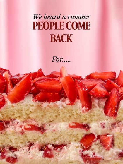 A tempting close-up of the Strawberry Bliss Cake's layers. It's a customer favorite that people come back for again and again.