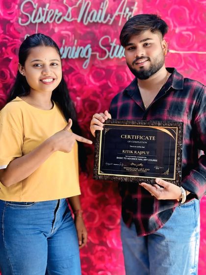 Another shot of Ritik, proudly pointing to his hard-earned certificate. He put in the work during his hands-on training and is now a certified nail artist.