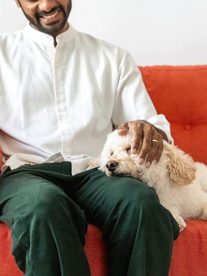 A quiet moment of trust and comfort. Dinkan rests his head on his dad's lap, showing the peaceful side of their relationship.