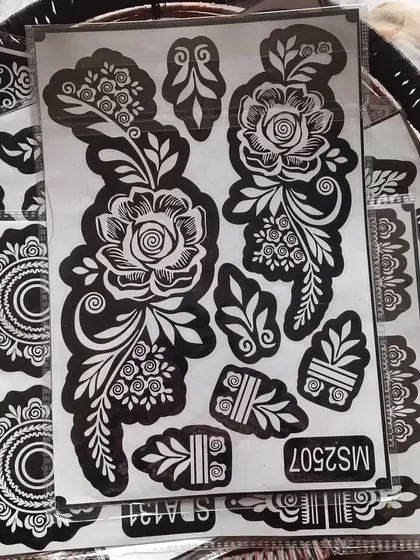 This stencil features a large, intricate rose design that looks stunning on the back of the hand. It also includes smaller elements to complete the look.