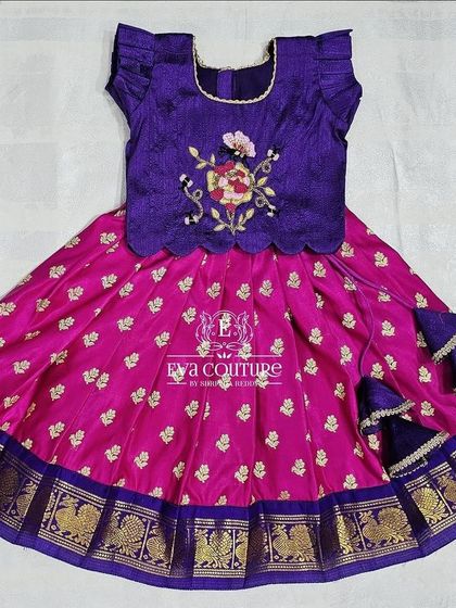 A beautiful purple and pink newborn Pattu Pavadai with floral embroidery, ready to be shipped.