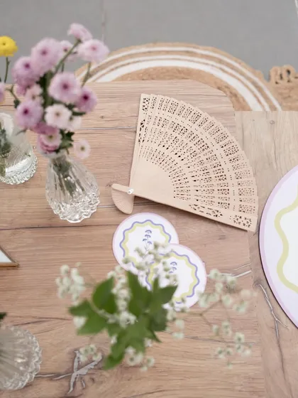 A close-up of the custom-designed coasters and hand fans, small details that enhance the guest experience.