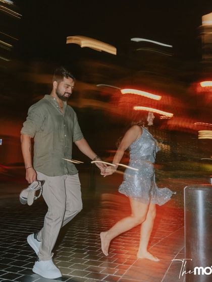 A pre-wedding story from the UAE desert. This motion-blur shot of the couple running barefoot at night captures the energy and magic of a shoot in Dubai.