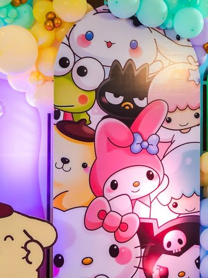 A vibrant backdrop featuring a collage of Hello Kitty and Sanrio characters.
