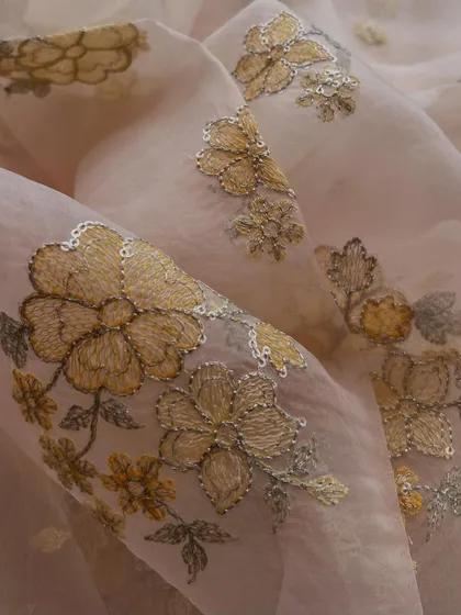 Delicate, dreamy, detailed. This embroidered organza with golden floral clusters and sequin accents adds a touch of magic to every stitch.