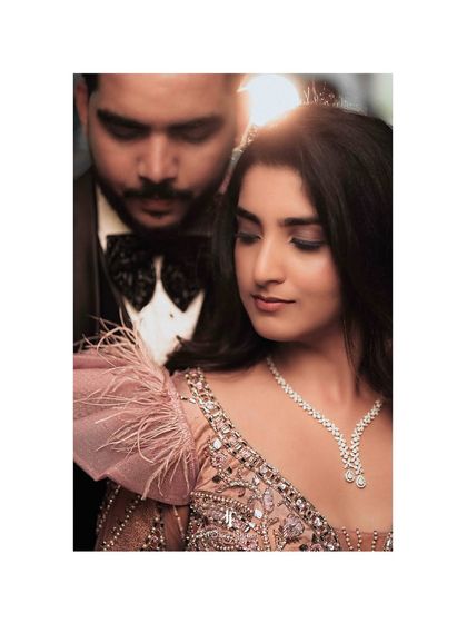 A close-up of the couple, highlighting the bride's beautiful reception gown and jewelry.