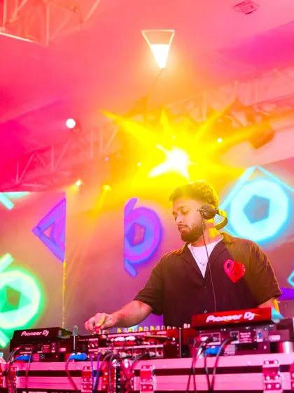 A colorful, high-energy shot of me at the decks. The vibrant lighting reflects the dynamic and eclectic nature of my music selection.