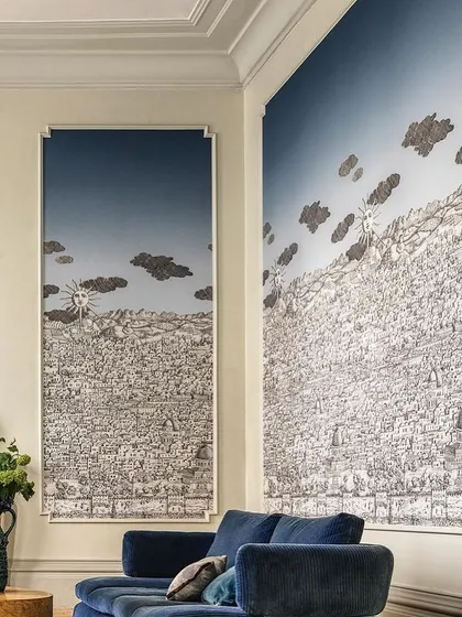 A fabulous way to showcase our wallpaper is within paneling. This creates depth and dimension, forming a focal point in any space, as seen here with this intricate, illustrative mural in a classic living room.