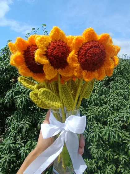 A bouquet of three classic sunflowers.