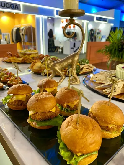 Mini chicken sliders, a perfect grab-and-go bite for guests at the Monkey 47 bar.