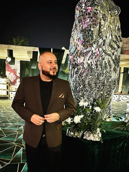 Keep it real. A candid shot of me at an event, standing next to a cool mirrored lion statue, just taking in the atmosphere.