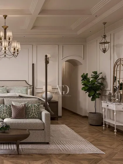 A cozy corner in a classic bedroom, featuring a comfortable sofa and distressed-finish console table. The herringbone wood floor and paneled walls provide a beautiful, textural backdrop.